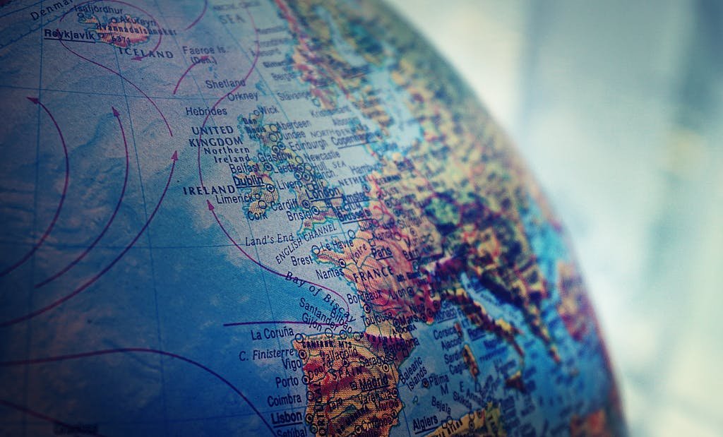 Photo by Suzy Hazelwood Detailed close-up of a globe showing parts of Europe and the Atlantic Ocean.
