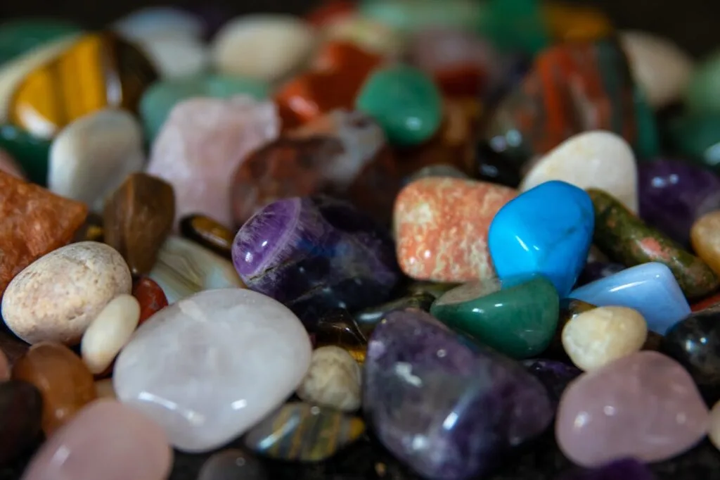 A close-up view of assorted polished gemstones with vibrant colors and textures.